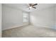 Bedroom with neutral carpet, a ceiling fan, and natural light from a window at 6416 Willow Pin Ln, Huntersville, NC 28078