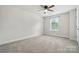 Bedroom with neutral carpet, a ceiling fan, and natural light from a window at 6416 Willow Pin Ln, Huntersville, NC 28078