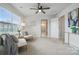 Bright bedroom boasts neutral decor, a ceiling fan, and a large window at 6416 Willow Pin Ln, Huntersville, NC 28078