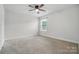 Bedroom with neutral carpet, a ceiling fan, and natural light from a window at 6416 Willow Pin Ln, Huntersville, NC 28078