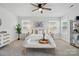 Bright bedroom with plush carpet, fan, large windows, and light neutral furniture at 6416 Willow Pin Ln, Huntersville, NC 28078