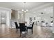 Inviting dining area with wood floors, modern lighting, and an open staircase near the entry way at 6416 Willow Pin Ln, Huntersville, NC 28078