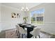 Elegant dining room with a modern table, chairs, chandelier, and natural light at 6416 Willow Pin Ln, Huntersville, NC 28078
