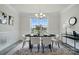 Formal dining room with a modern chandelier, wainscoting, and a large window at 6416 Willow Pin Ln, Huntersville, NC 28078