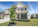 Charming home featuring stone accents, black shutters, a covered porch, and well-maintained landscaping at 6416 Willow Pin Ln, Huntersville, NC 28078