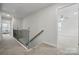 Second story hallway with carpet and an open doorway into another bedroom or living space at 6416 Willow Pin Ln, Huntersville, NC 28078