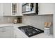 Close-up view of a modern kitchen with stainless steel appliances and herringbone backsplash at 6416 Willow Pin Ln, Huntersville, NC 28078