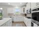 Well-lit kitchen features modern appliances, countertops, and herringbone backsplash at 6416 Willow Pin Ln, Huntersville, NC 28078