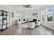 Cozy living room featuring a fireplace, hardwood floors, stylish furnishings, and lots of light at 6416 Willow Pin Ln, Huntersville, NC 28078