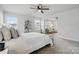 Bedroom suite with plush carpet, large windows, and small sitting room at 6416 Willow Pin Ln, Huntersville, NC 28078