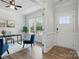 Bright office space with hardwood floors, a large window, and a stylish accent chair, plus front door view at 6416 Willow Pin Ln, Huntersville, NC 28078