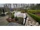 Secluded backyard featuring a pond, white picket fence, and mature trees at 700 Valleyview Dr # 1, Albemarle, NC 28001