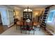 Spacious dining room featuring elegant chandelier, large windows, and stylish decor at 700 Valleyview Dr # 1, Albemarle, NC 28001
