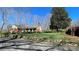 Beautifully landscaped front yard with lush green grass, mature trees, and a charming stone wall at 700 Valleyview Dr # 1, Albemarle, NC 28001