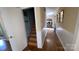 Hallway featuring hardwood floors and access to the basement stairs, showcasing home's layout at 700 Valleyview Dr # 1, Albemarle, NC 28001
