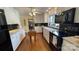 Bright kitchen with white cabinets, granite countertops, and a black backsplash at 700 Valleyview Dr # 1, Albemarle, NC 28001