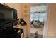 Clean kitchen with electric cooktop stove and view to the sunroom at 700 Valleyview Dr # 1, Albemarle, NC 28001