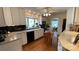 Charming kitchen featuring white cabinets, granite countertops, and hardwood floors at 700 Valleyview Dr # 1, Albemarle, NC 28001