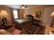 Well-lit primary bedroom boasts hardwood floors, a cozy area rug, and views of the outside at 700 Valleyview Dr # 1, Albemarle, NC 28001