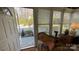 Bright sunroom with garden view, white trim and wicker furniture at 700 Valleyview Dr # 1, Albemarle, NC 28001