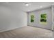 Bright bedroom features plush carpeting, two windows with natural light, and neutral-toned walls at 706 Live Oak St, Shelby, NC 28150