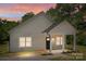 Charming home featuring a covered porch with white columns and beautiful sunset sky at 706 Live Oak St, Shelby, NC 28150