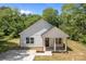 Inviting single-Gathering home featuring a covered front porch, new landscaping, and a well-maintained yard at 706 Live Oak St, Shelby, NC 28150