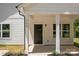 Inviting covered front porch with classic columns and a dark front door at 706 Live Oak St, Shelby, NC 28150