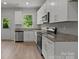 Bright kitchen featuring stainless steel appliances, granite counters and white cabinets at 706 Live Oak St, Shelby, NC 28150