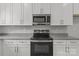 This modern kitchen features white cabinets, stainless steel appliances, and granite countertops at 706 Live Oak St, Shelby, NC 28150