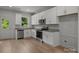Bright kitchen featuring stainless steel appliances, granite counters and white cabinets at 706 Live Oak St, Shelby, NC 28150