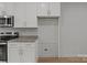 A functional kitchen offers granite countertops, white cabinets, and room for a refrigerator at 706 Live Oak St, Shelby, NC 28150