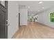 Open-concept living room with light wood floors leading to the kitchen at 706 Live Oak St, Shelby, NC 28150