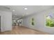 Open-concept living room with light wood floors leading to the kitchen at 706 Live Oak St, Shelby, NC 28150