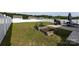Spacious fenced backyard with a well-manicured lawn, patio, garden beds, and an outdoor dining area at 7315 Amberly Hills Rd, Charlotte, NC 28215