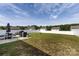 Spacious fenced backyard with a patio, grill, dining set, fire pit, and a manicured lawn, perfect for outdoor living at 7315 Amberly Hills Rd, Charlotte, NC 28215