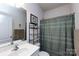 This bathroom offers a shower and bathtub combo with a large mirror and great natural light at 7315 Amberly Hills Rd, Charlotte, NC 28215