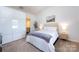 Cozy bedroom with soft carpet, a comfortable bed, and stylish decor at 7315 Amberly Hills Rd, Charlotte, NC 28215