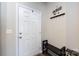 Cozy entryway with a white door, coat rack, and a bench, creating a functional and organized space at 7315 Amberly Hills Rd, Charlotte, NC 28215