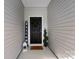 Welcoming entrance featuring a decorated front door, a 'welcome' sign, and a charming lantern decor at 7315 Amberly Hills Rd, Charlotte, NC 28215