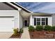 Attractive single-story home featuring a two-car garage, charming front porch, and well-maintained landscaping at 7315 Amberly Hills Rd, Charlotte, NC 28215