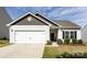 Inviting single-story home showcasing a two-car garage, neatly landscaped front yard, and welcoming entrance at 7315 Amberly Hills Rd, Charlotte, NC 28215