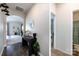 Open hallway showcasing a desk with decor, leading to the living area, with a bathroom and bedroom entrance at 7315 Amberly Hills Rd, Charlotte, NC 28215