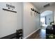 Hallway featuring modern lighting, stylish bench, and a clear view into the adjacent dining area at 7315 Amberly Hills Rd, Charlotte, NC 28215