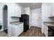Well-lit kitchen showcasing white cabinetry, granite countertops, black appliances, and wood-look flooring at 7315 Amberly Hills Rd, Charlotte, NC 28215