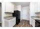 Well-lit kitchen showcasing white cabinetry, granite countertops, black appliances, and wood-look flooring at 7315 Amberly Hills Rd, Charlotte, NC 28215
