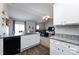 Open concept kitchen with granite countertops, white cabinets, black appliances, and seamless flow to the living area at 7315 Amberly Hills Rd, Charlotte, NC 28215