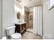 This bathroom features a tile shower and flooring, a vanity with storage, and updated fixtures at 8 Cauthen St, Rock Hill, SC 29730