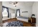 This bedroom features hardwood floors, natural light, a ceiling fan, and blue accents at 8 Cauthen St, Rock Hill, SC 29730