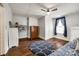 This bedroom features hardwood floors, natural light, a ceiling fan, and blue accents at 8 Cauthen St, Rock Hill, SC 29730